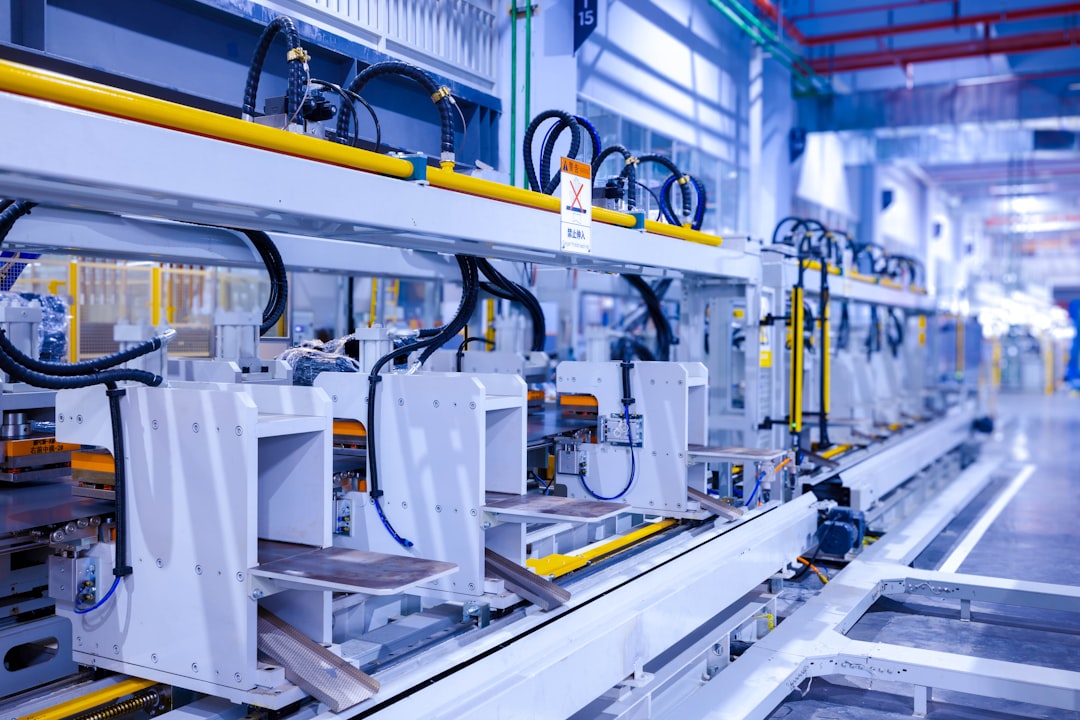 Industrial production line of a refrigerator manufacturing plant Translation: WARNING Danger! Prohibit reach into